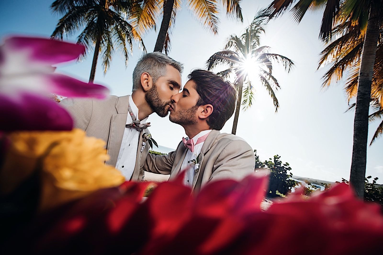 Grooms kissing on a photoshoot at Copamarina Weddings