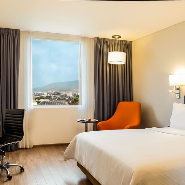 King bed with sofa in Superior Room at Fiesta Inn