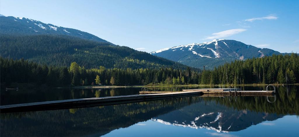 Scenic view of Lost Lake with snow-capped mountains in Whistler