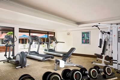 Fully equipped gymnasium with carpeted floors at York Hotel Singapore