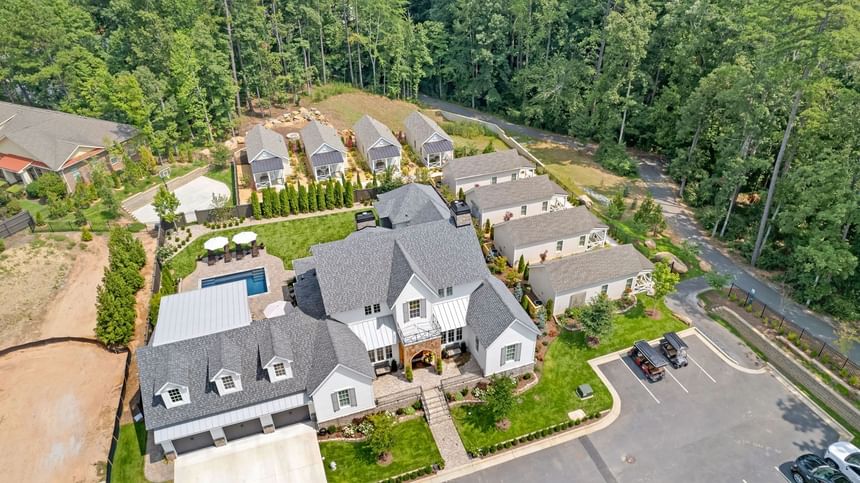 Aerial view of luxury Cottages at Laurel Brooke with pool, landscaped gardens, and guest cottages in a wooded area