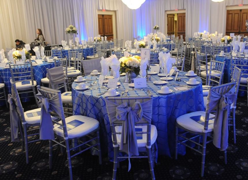 Banquet tables arranged for an event at UMass Lowell Inn
