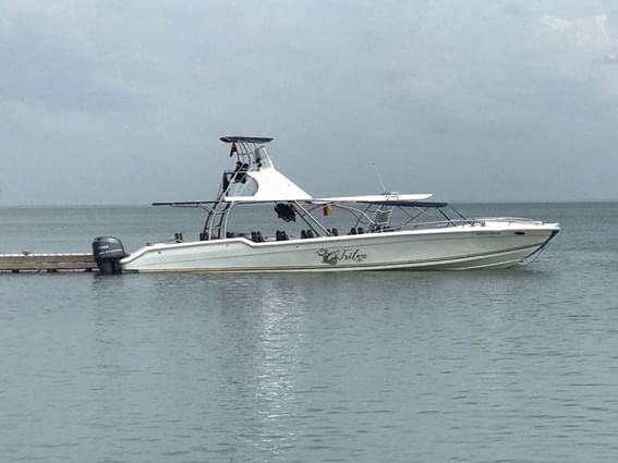 JJ sport boat parked by the deck on the sea near Hotel Isla Del Encanto