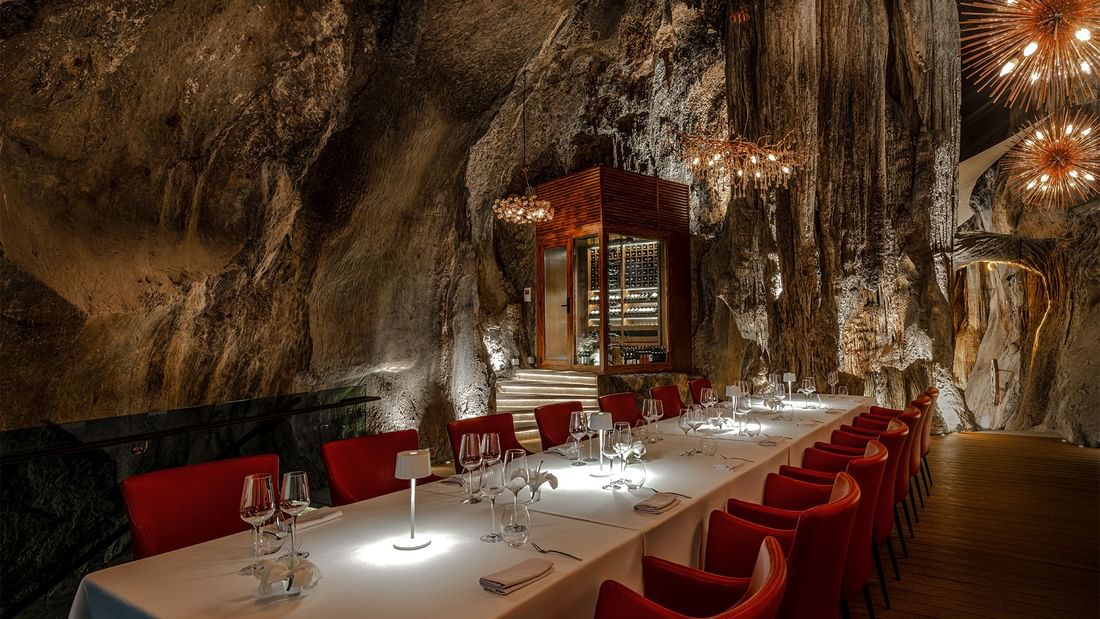 Private dining room with long table and red chairs in Jeff's Cellar at The Banjaran Hotsprings Retreat Ipoh.