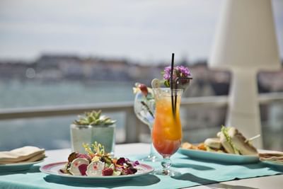 Appetizers served with fresh juice in Cristóvão Colombo Bar at Hotel Cascais Miragem Health & Spa