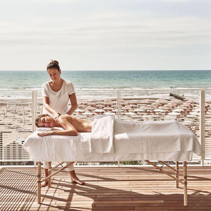 Lady receiving a massage on a spa balcony, Falkensteiner Hotels