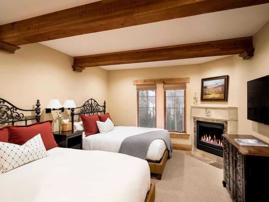 Two beds and fireplace in Queen Room at Chateaux Deer Valley