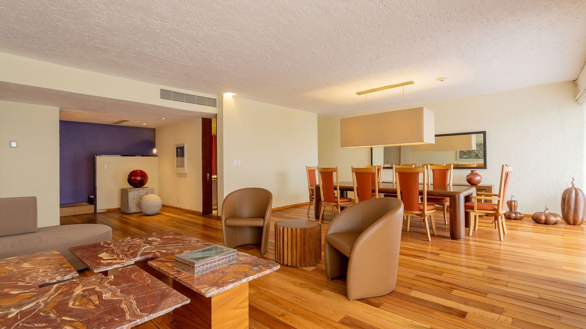 King Viceroys Suite with marble tables, wood floors, and a large dining area at Camino Real Polanco Mexico