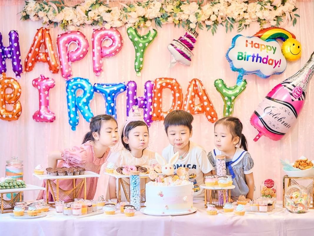 Children blowing candles in a Birthday Party at Park Hotel Hong Kong