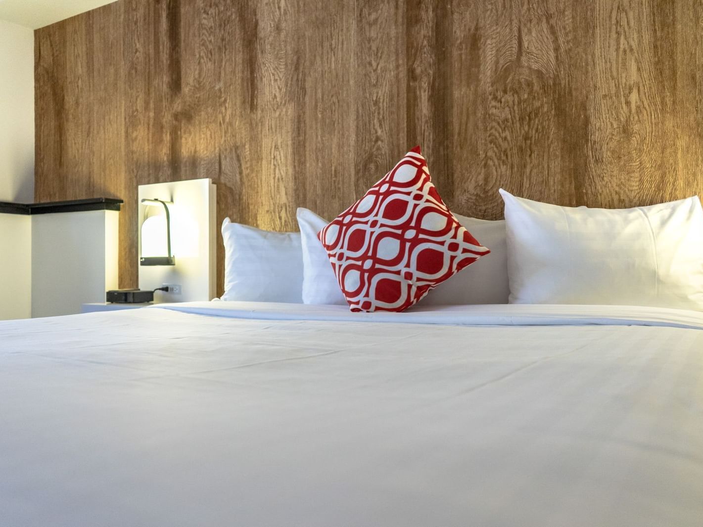 Bed in hotel room with wooden walls