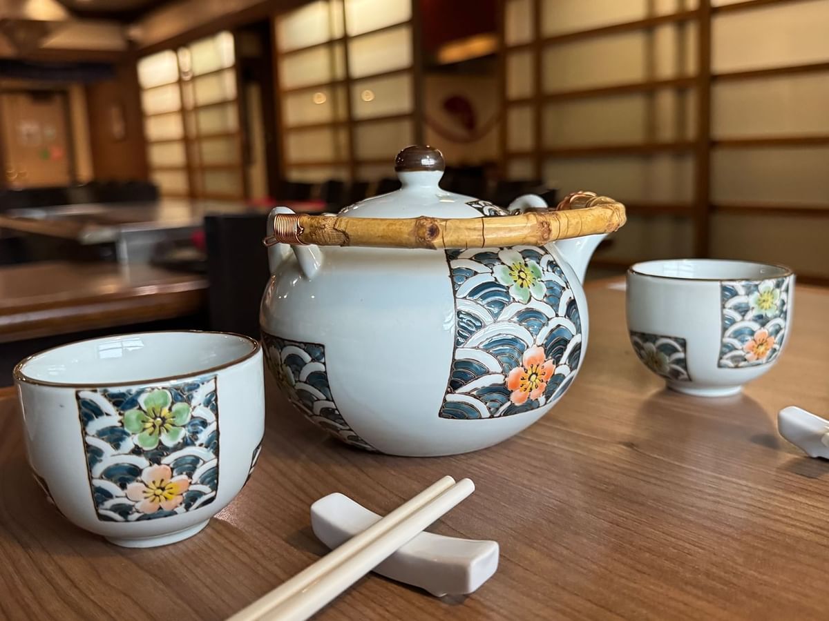 A teapot and three cups.