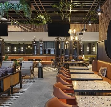 Cafe interior with plush seating and ornaments in Winter Garden at Titanic Comfort Kurfürstendamm