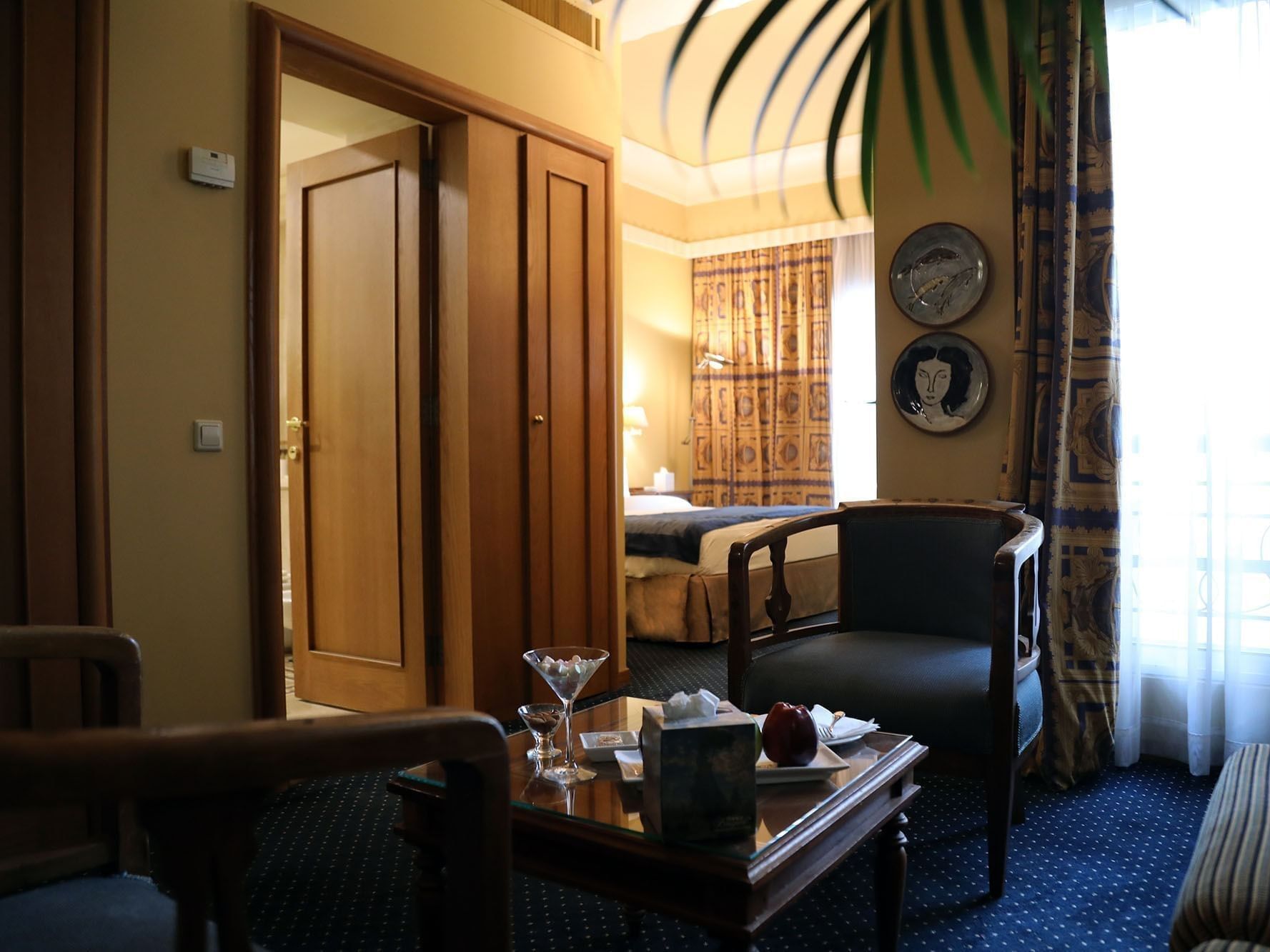 Couch with coffee table near doorway to bedroom in Executive Suite at Warwick Palm Beach Hotel