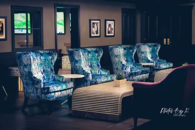 row of chairs and tables in a lobby