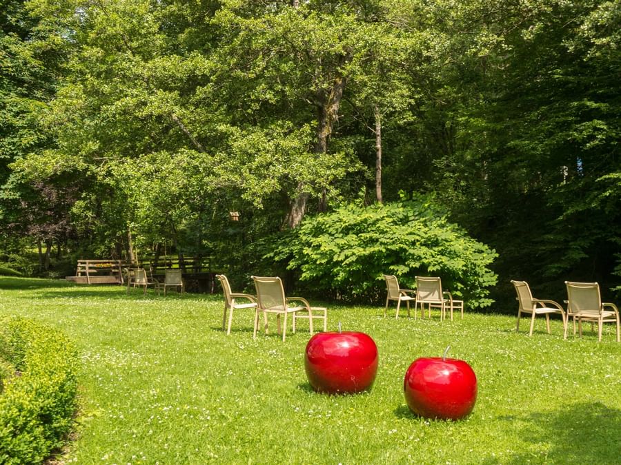 An outdoor lounge area by the lawn at Moulin de Daverdisse