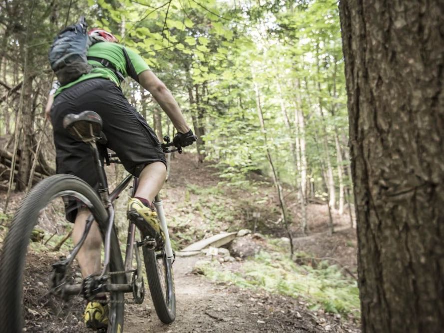 A man cycling at the mountains near Topnotch Stowe Resort