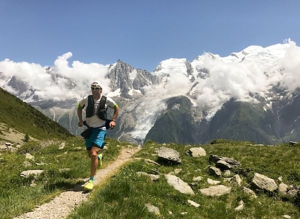 Man running on a trail with a scenery view near Blackcomb Springs Suites