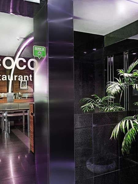 O'cocco Restaurant entrance by green plants under purple neon lights at Warwick Stone 55 - Beirut