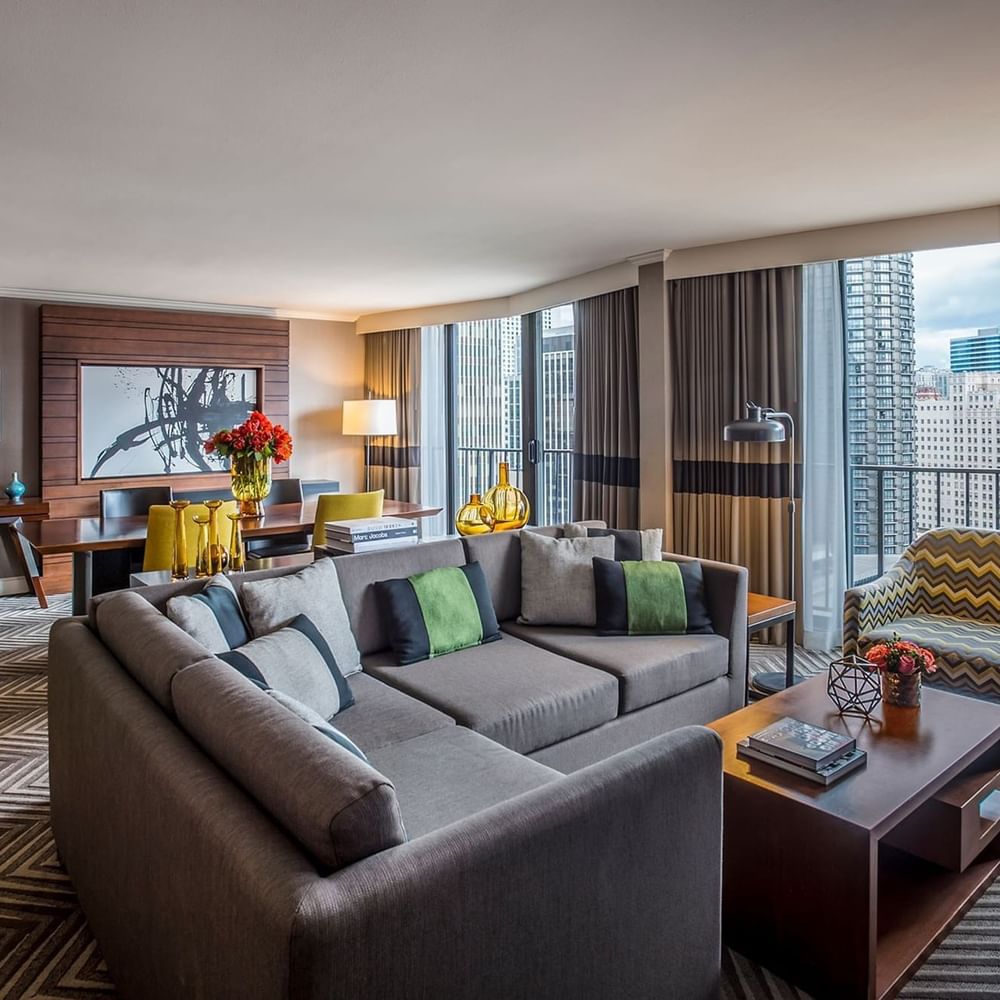 Living area featuring a grey sofa by a wooden coffee table inEmerald Suite (1908) at Warwick Seattle