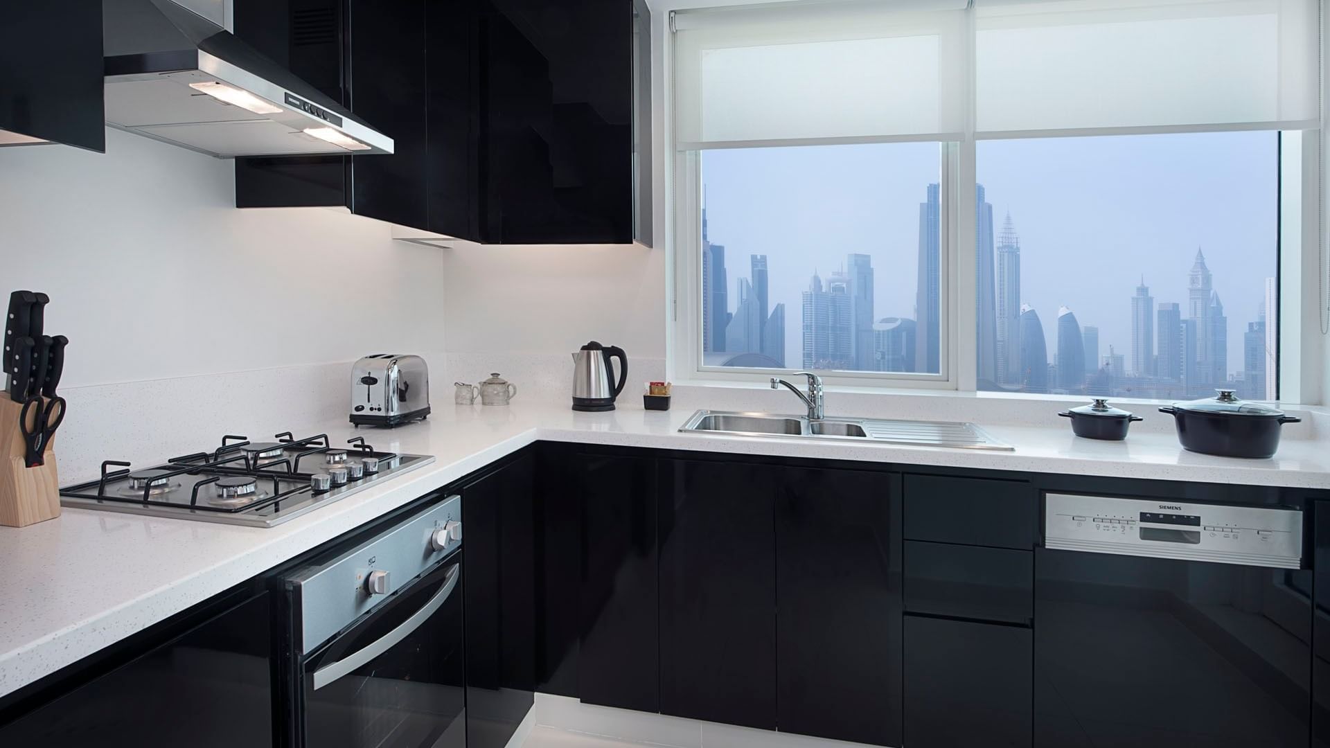 Fully equipped kitchen with appliances in Two Bedroom Suite at DAMAC Maison Canal Views
