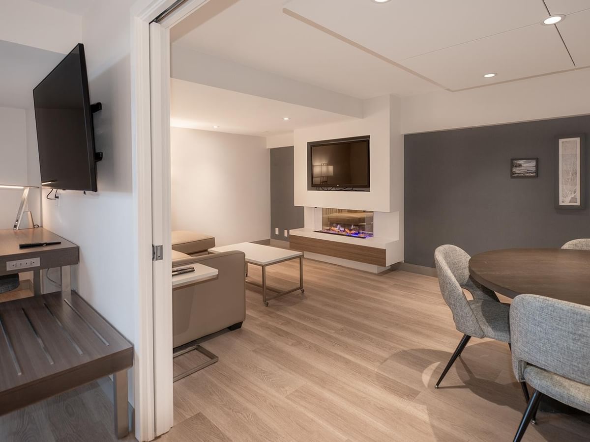 Modern suite with a fireplace and dining area at Coast Bastion Hotel in Nanaimo.