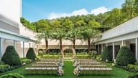 Outdoor wedding chair set-up with flower decorations in The Courtyard at Ocean Park Hotel Hong Kong