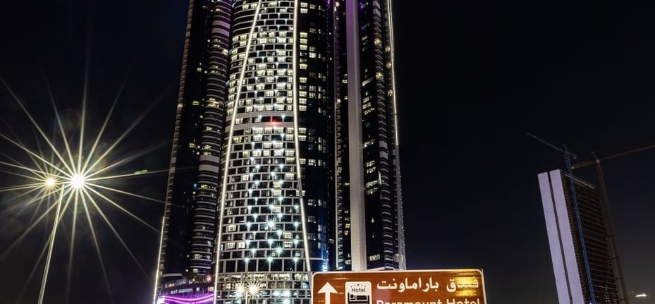 Low-angle exterior view of Paramount Hotel Dubai & street at night