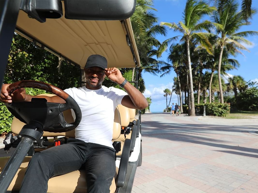 Man driving golf cart near Boulan South Beach Hotel