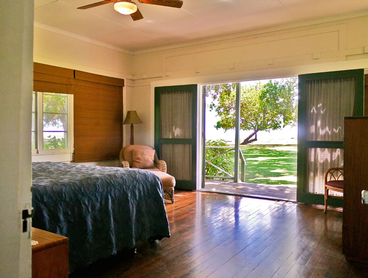 Guest room with sliding door at Waimea Plantation Cottages