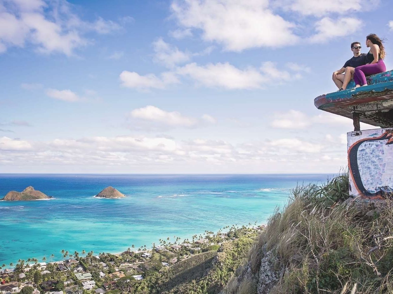 Couple enjoying the view form Lanikai Pillbox near Waikiki Resort Hotel by Sono