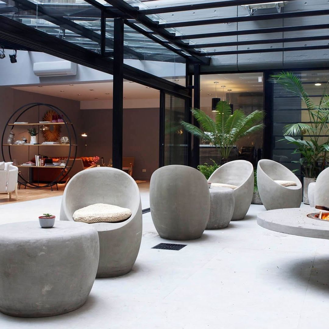 Interior of the patio with lounge chairs at DecO Recoleta Hotel
