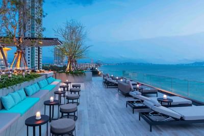 Lounge area with blue sea and mountain background at U JOMTIEN