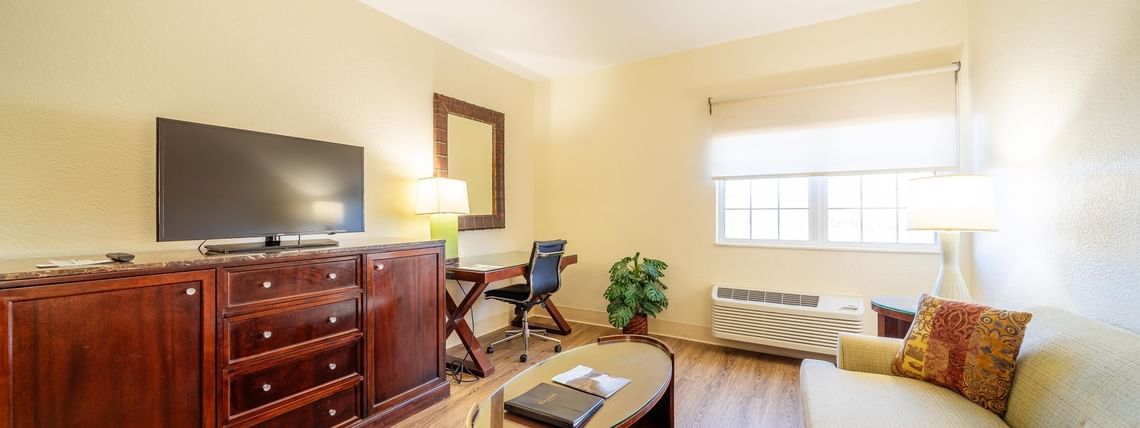 TV lounge area with workspace in Suite Room at South Branch Inn Moorefield