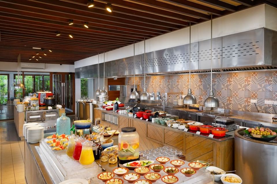 The Edge's buffet serving area with various dishes and beverages at Grand Park Kodhipparu, Maldives