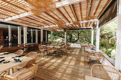 Azure Restaurant & Bar dining area with wicker chairs at Barefoot Cay Resort & Marina