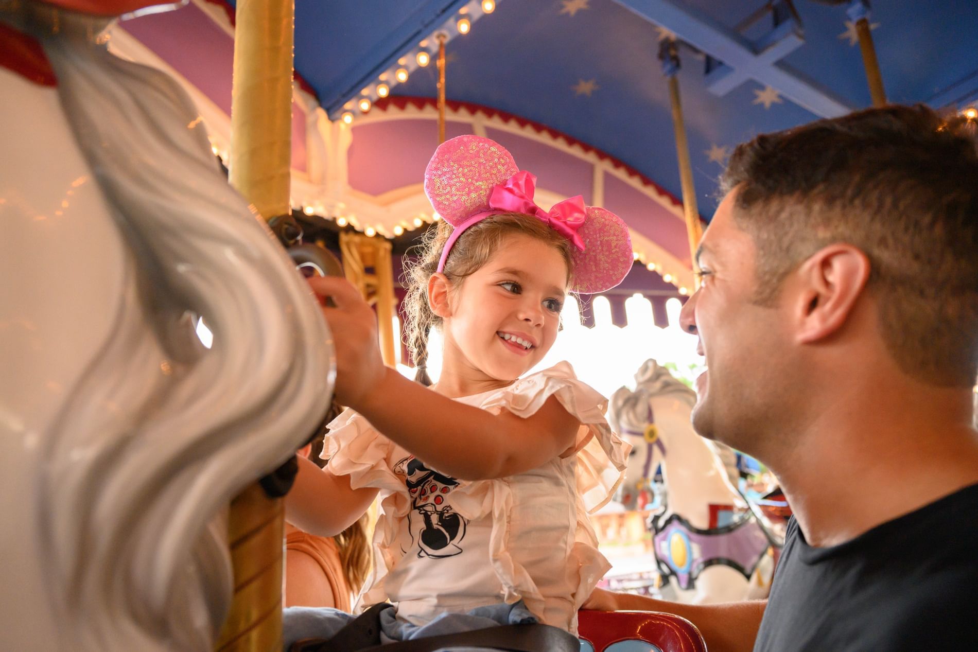 Child on a carousel ride at Magic Kingdom near Lake Buena Vista Resort Village & Spa