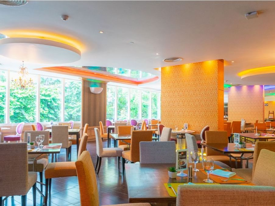 Colorful separated tables &chairs in hall at Dream Downtown NYC