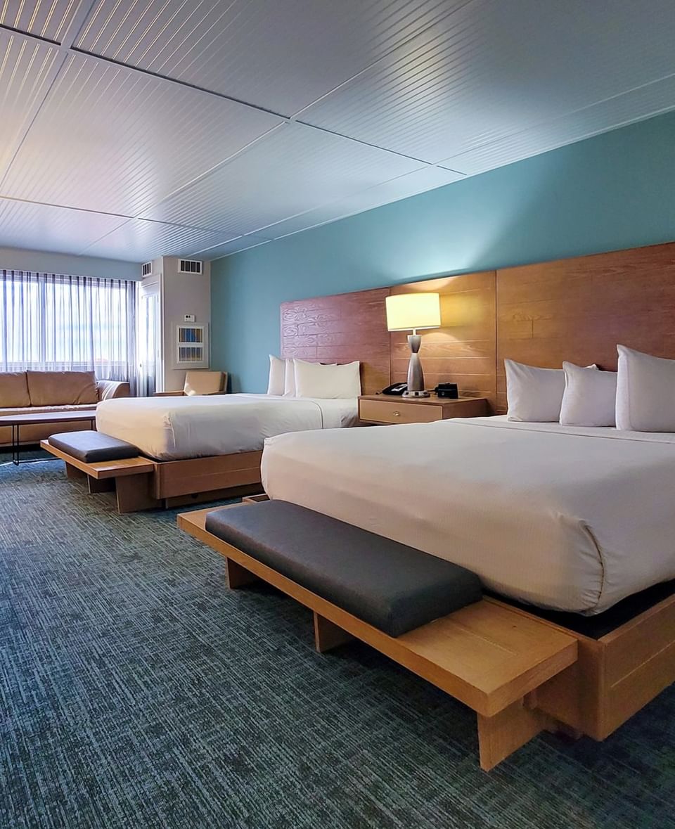 Double Queen No Balcony with two queen beds featuring blue walls and a wooden headboard at Margaritaville Resort Biloxi