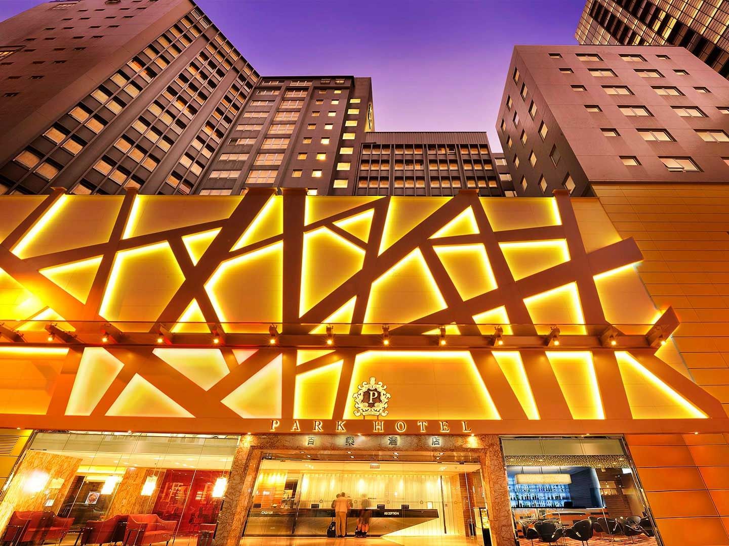 Low angle exterior view of Park Hotel Hong Kong with lit lights at night