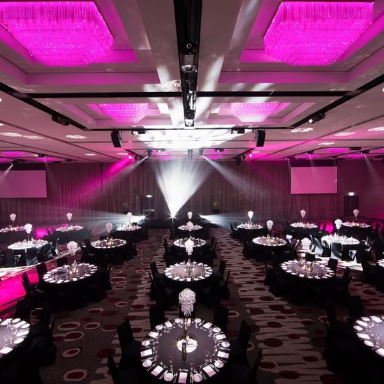 Banquet set-up in illuminated Grand Ballroom with carpeted floors at Pullman Albert Park