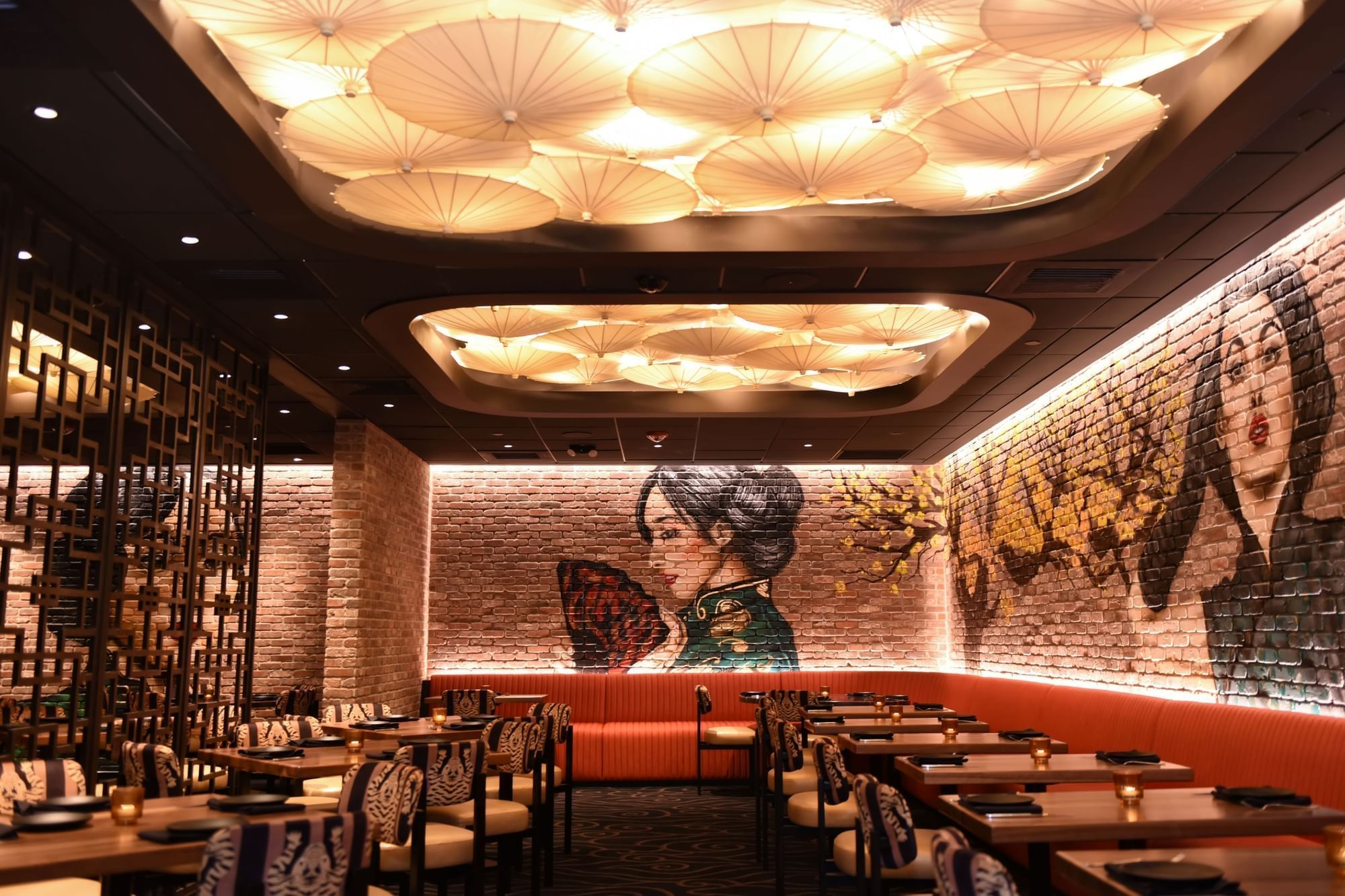 9 Dragons featuring striped chairs by wooden tables under a paper umbrella ceiling near murals at The Brook