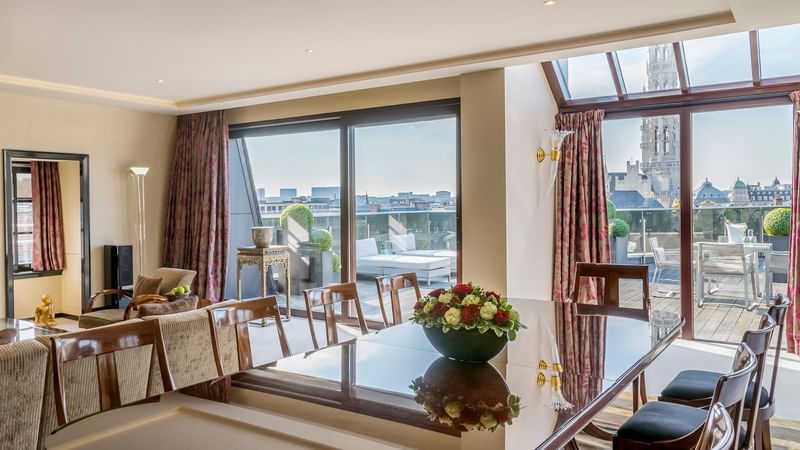 Dining and living area with city view in Grand Place Suite at Warwick Brussels