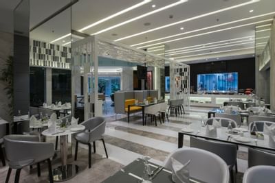 Illuminated dining area with amenities in The Glass House at Eastin Residences Vadodara