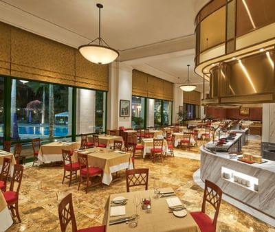 Dining area arranged with tables & chairs at Hanoi Daewoo Hotel