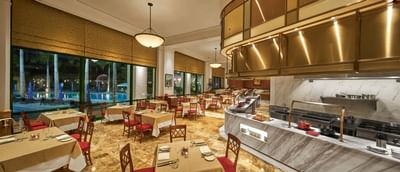 Dining area arranged with tables & chairs at Hanoi Daewoo Hotel