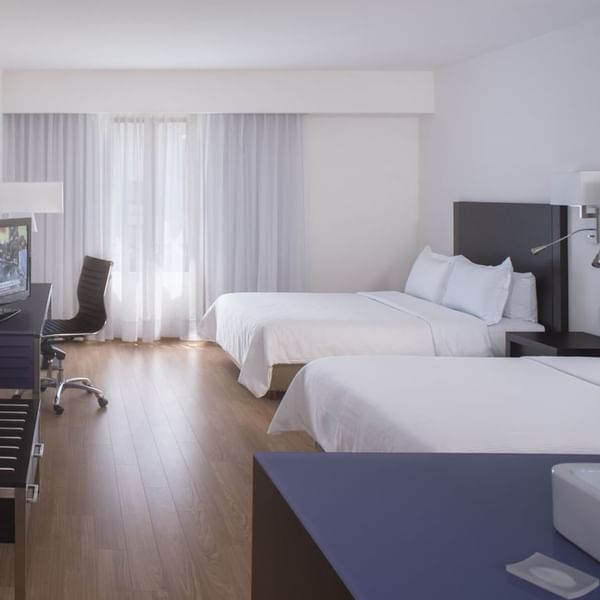 Twin beds with working desk in Superior Room at Fiesta Inn