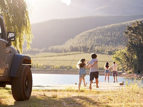 family looking at lake outside