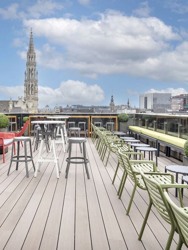 Grand-Place Suite rooftop terrace seating area under a sunset sky and city views at Warwick Grand Place Brussels