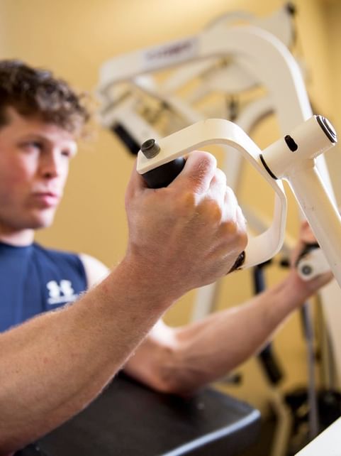 Man working out with the fitness equipment in the Gym at Cove Pocono Resorts