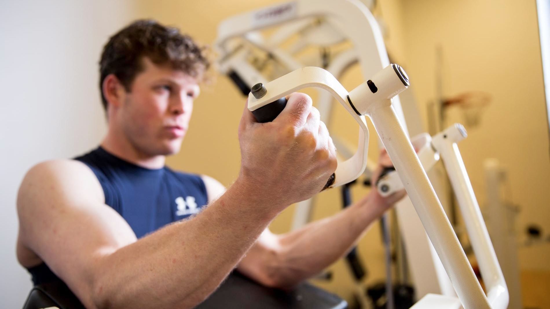 Man working out with the fitness equipment in the Gym at Cove Pocono Resorts